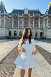 a lady wears a white tweed top with matching skorts